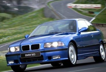 A BMW M3 soaring around a corner in the Gran Turismo 7 update for July 2024